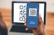 © Prostock-studio - Unrecognizable black man scanning qr code by smartphone from laptop