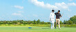 © freebird7977 - Group golf playing. Professional Golfer asian man walking and hug for friendship after finish put golf ball on green. Hobby relax in holiday and vacation with friends.  copy space for banner
