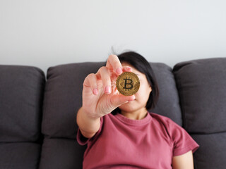 Woman carrying bitcoin in business