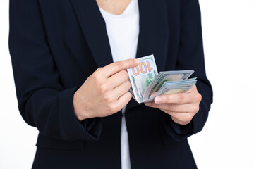 Wall Mural - Business woman holding 100 dollars in hand over white background. economy and business concept background, banner.