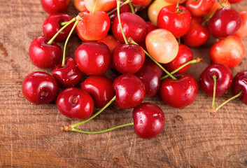 Wall Mural - Cherries on wooden table with water drops