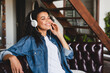 © InsideCreativeHouse - Happy relaxed african girl listening to the music in headphones at home. Happy relaxed african woman wear wireless headphones listening to lounge music relaxing after work