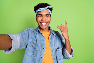 Poster - Photo of guy take selfie show fingers horns wear piercing headband jeans shirt isolated green color background