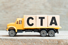 Toy Truck Hold Alphabet Letter Block In Word CTA (Abbreviation Of Call To Action Or Chartered Tax Adviser) On Wood Background