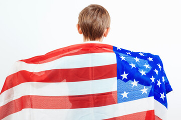 Little patriot with American flag back view. Happy child holding a flag of America. Independence Day concept.