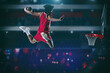 © alphaspirit - Basketball game with a high jump player to make a slam dunk to the basket