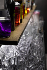 Wall Mural - Vertical shot of empty crystal glasses on the bar table