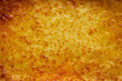 Background texture of melted mozzarella cheese on a lasagne or pizza base