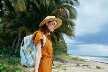 Canvas Print - woman with backpack in nature near the sea on the island travel tourism model