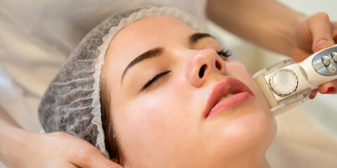 Wall Mural - Close up of woman face, lying down in spa salon and have face cleaning procedure.