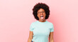 afro black woman with cheerful, carefree, rebellious attitude, joking and sticking tongue out, having fun
