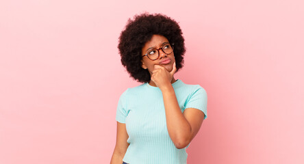 Wall Mural - afro black woman thinking, feeling doubtful and confused, with different options, wondering which decision to make