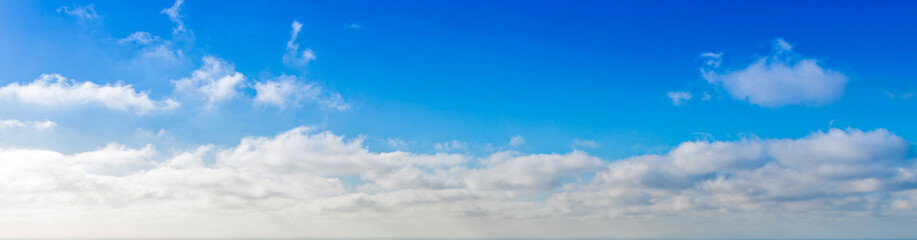 Wall Mural - Blue sky increasingly loaded with a sea of clouds on the island of Santorini