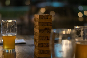 Poster - Closeup of glasses of beer with wooden blocks on the table