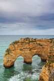 Fototapeta Do akwarium - Landscape on the Algarve coast at sunset. Beach in southern Portugal the best travel destination for tourists on vacation. seascape with caves through the cliffs