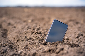 the phone sticks out of the ground in the field