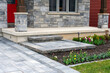 Luxury residential landscaping and front garden shows a precast paver landing, steps and driveway with matching pattern.