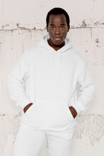 White Hoodie On Man With Concrete Wall