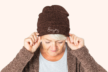 Poster - Senior woman in red beanie for winter apparel