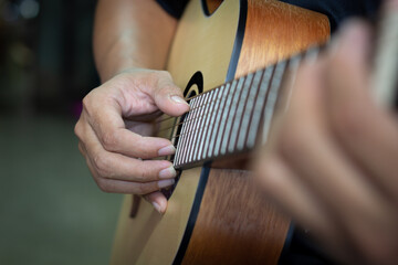 A close up of a musician playing the guitar