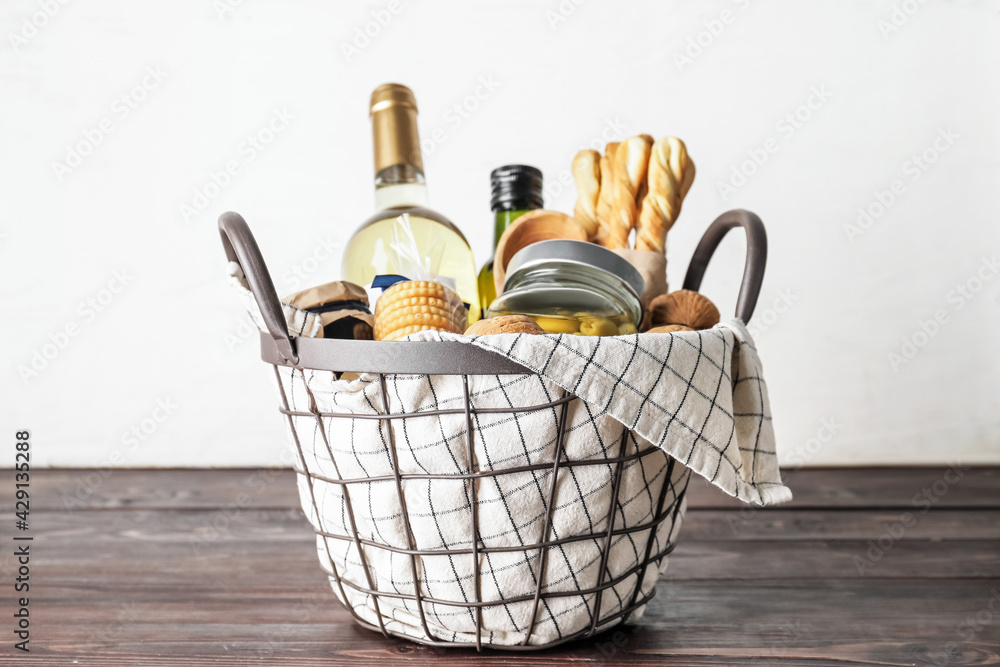 Gift basket with products on wooden table