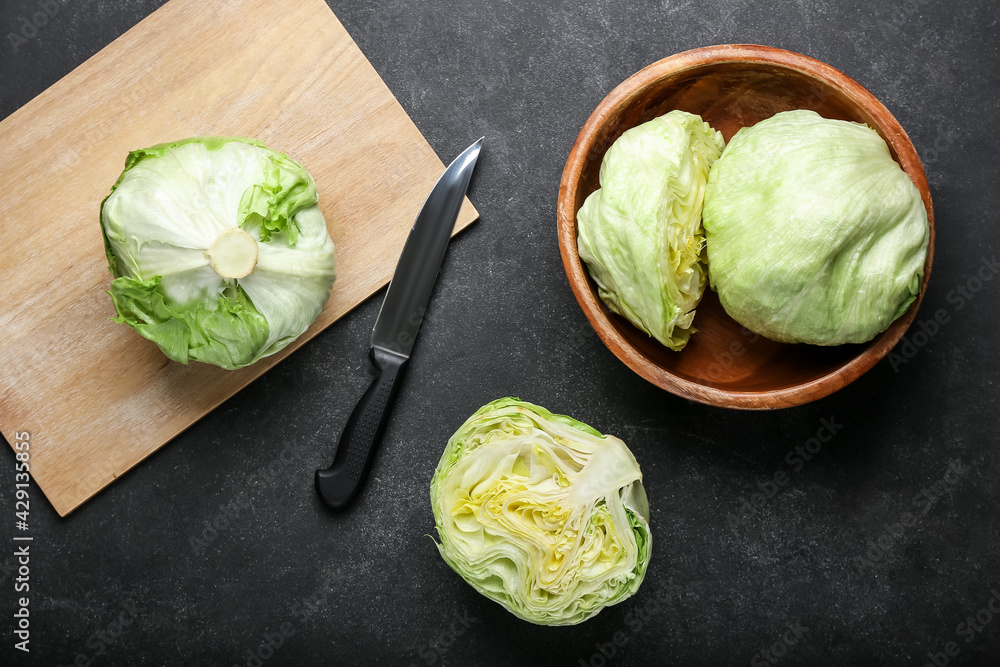 Bowl with iceberg lettuce on dark background