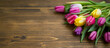 Spring tulips bouquet on wooden copy space background