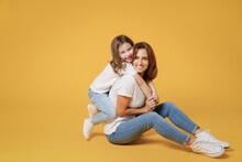 Full Body Length Happy Woman In Basic White T-shirt Have Fun Sit On Floor Child Baby Girl 5-6 Years Old Mom Mum Little Kid Daughter Isolated On Yellow Color Background Studio Mother's Day Love Family.
