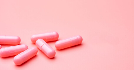 Canvas Print - Pink capsules pill on pink background. Vitamins and supplements. Online pharmacy. Pharmacy store banner. Pharmaceutical industry. Woman's health insurance concept. Pills for love and happy life.