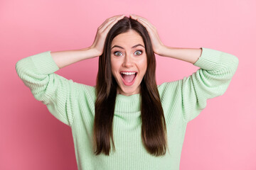 Sticker - Portrait of impressed sweet brunette girl hands hair wear lime shirt isolated on pink color background