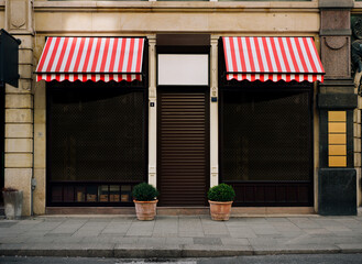 photo of closed and locked clothier or dress outfitter, shop front, impact of the corona virus pandemic 2021 in Germany.