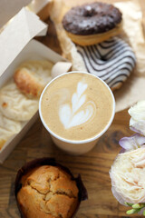 Wall Mural - Cappuccino in a paper cup and assorted food