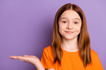 Wall Mural - Portrait of attractive cheery cute girl holding on palm copy empty blank space isolated over violet purple color background