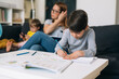 © cherryandbees - child does homework with his mother at home