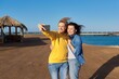 © Valerii Honcharuk - Two mature happy women taking selfie photo together using smartphone