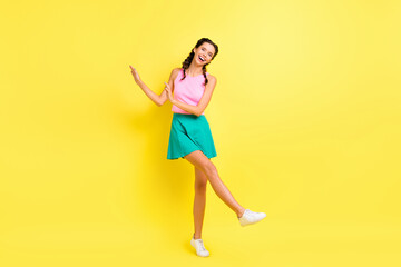 Wall Mural - Full size photo of optimistic cool brunette lady dance wear pink top blue skirt isolated on vivid yellow color background