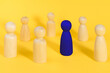 © photo-lime - Blue wooden figure among many yellow figures. Standing out from crowd, individuality, leadership, be unique minimal idea . Think different business creative concept