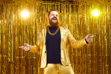 Happy Chubby Guy Having Fun At Concert Or Disco Party. Rich Young Man In Shiny Jacket And Gold Chain Necklace Singing And Dancing On Nightclub Stage With Glittering Foil Fringe Curtain Background