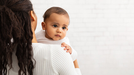 Wall Mural - African American Mother Posing With Cute Baby Over Gray Wall