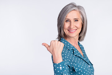 Poster - Photo of happy smiling cheerful businesswoman point finger copyspace advertisement isolated on grey color background