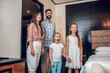 © zinkevych - Young sweet family standing in the room and looking excited