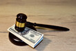 © MaxSafaniuk - Judge hammer and bundles of dollars. Justice in courtroom. Mallet of judge on law theme and legal system. Risk tools help judges decide and punishment. World bribery and scam. Credit and financial