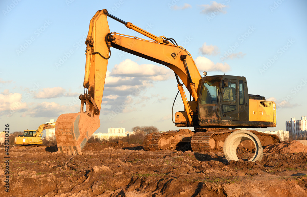 Excavator dig the trenches at a construction site. Trench for laying ...