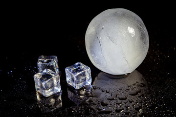 Wall Mural - ice ball reflection on black background.