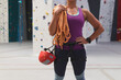 © Wavebreak Media - Midsection of caucasian woman with helmet and rope preparing for climb at indoor climbing wall