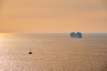 Cruise ship silhouette in Aegean sea on sunset