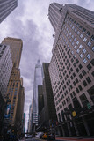 Fototapeta Uliczki - Looking up on Manhattan skyscrapers with wide angle perspective 