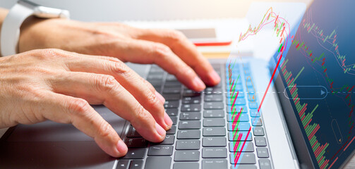 Businessman using laptop computer and sale data graph on strategy marketing on global network connection. Digital online marketing,