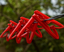 Red Clothespin Hanging On A Wire