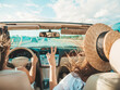 © halayalex - Portrait of two young beautiful and smiling hipster female in convertible car. Sexy carefree women driving cabriolet. Positive models riding and having fun in sunglasses outdoors.Enjoying summer days
